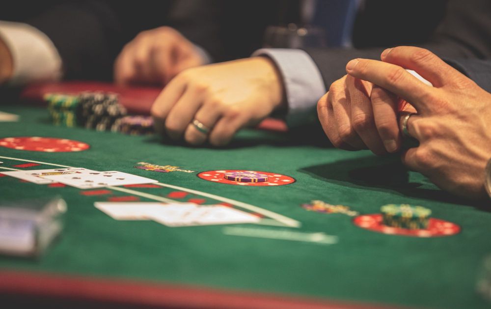 Cards and gaming chips on the baize of a card table, dealt in person